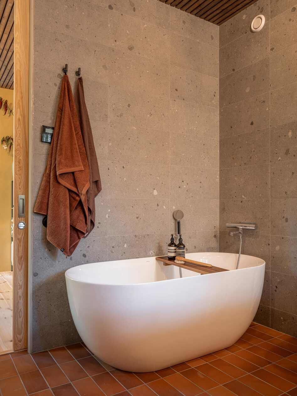 An Architectural Wooden Home with Open Spaces 20 freestanding-bath-gray-tiles-nordroom