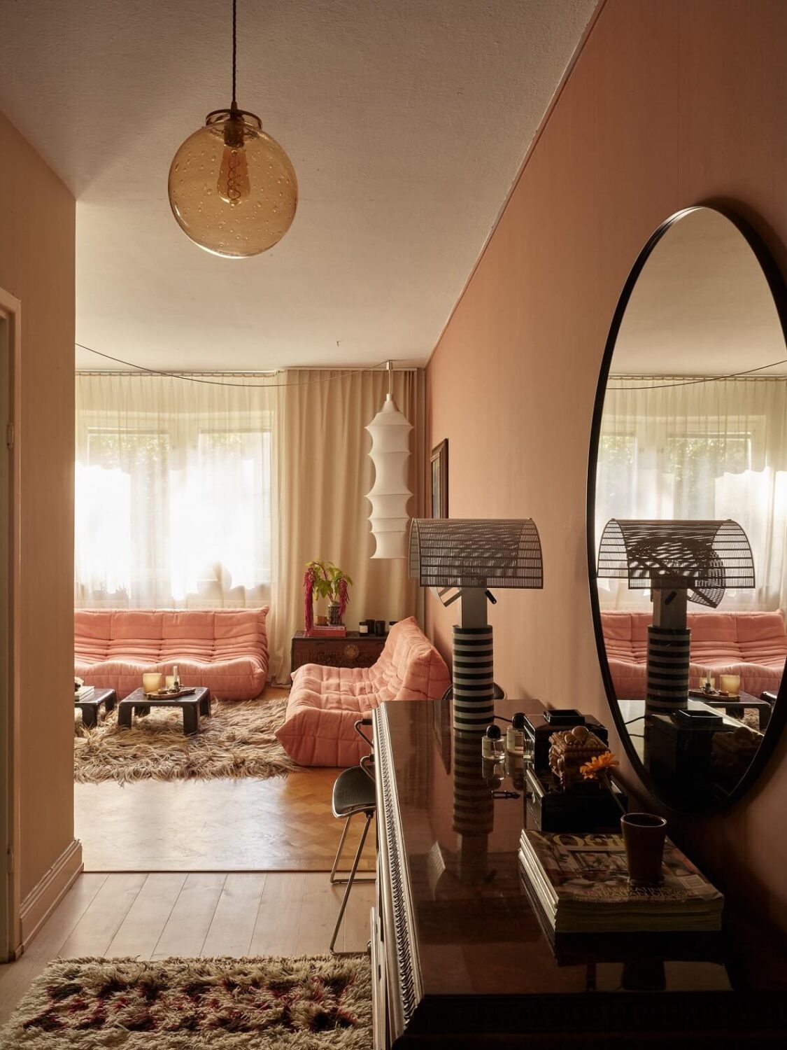 Warm Pink Tones in A Stockholm Apartment 12 hallway-round-mirror-warm-pink-accent-wall-nordroom