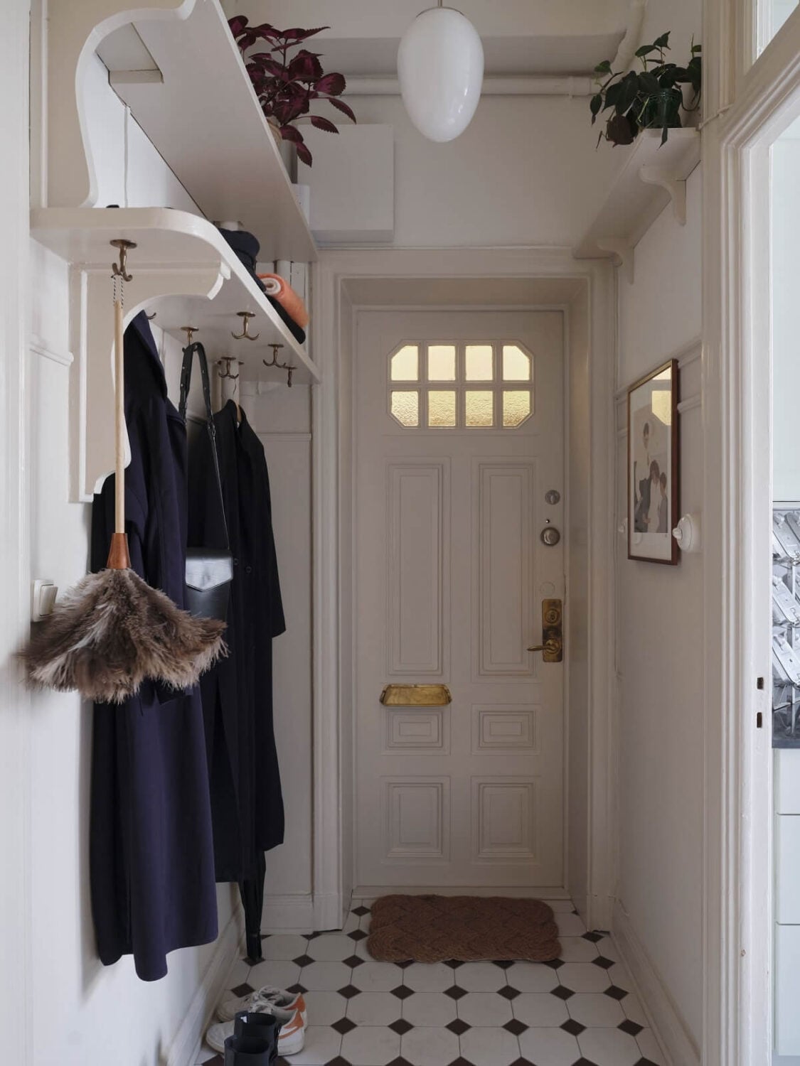 A Light Scandinavian Apartment with Classic Touches 24 hallway-shelves-black-white-floor-tiles-nordroom