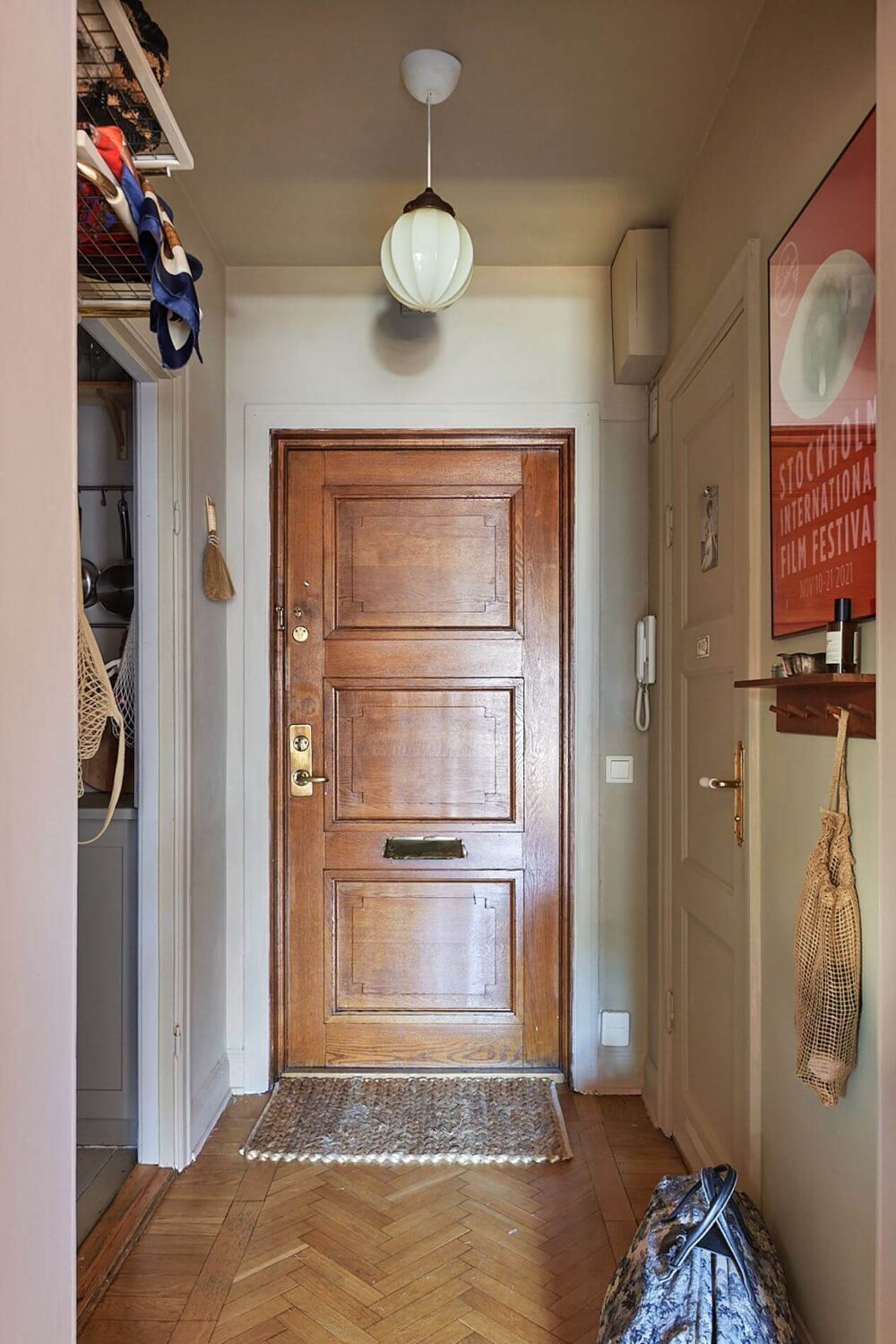 A Scandinavian Studio Apartment with Pink Walls 15 hallway-wooden-floor-studio