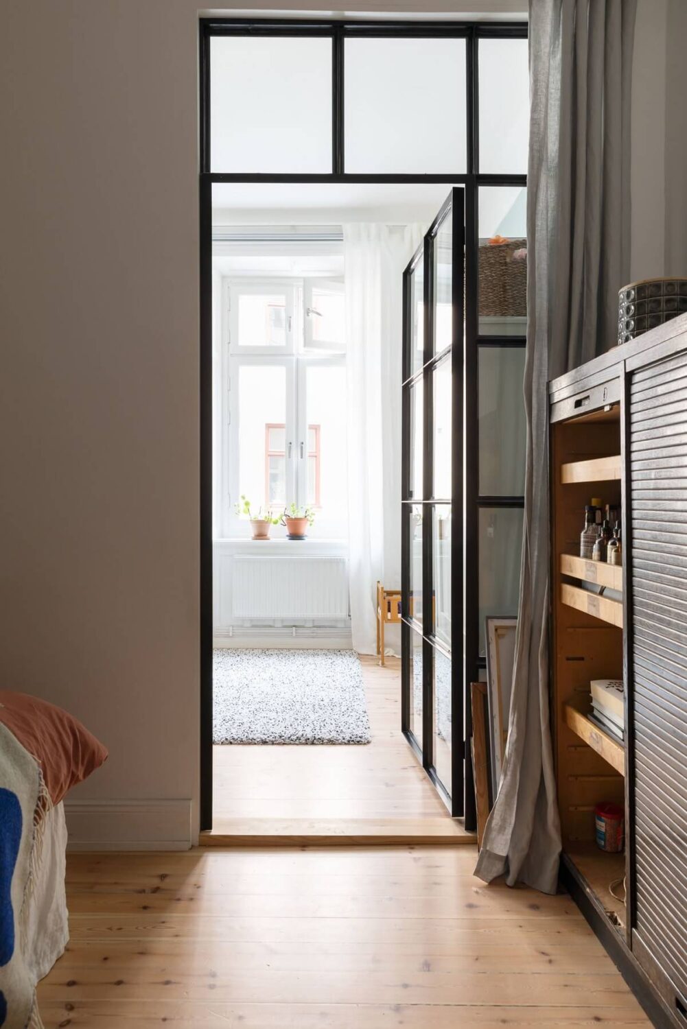 A Bright Scandinavian Apartment with a Light Gray Kitchen 22 industrial-glass-door