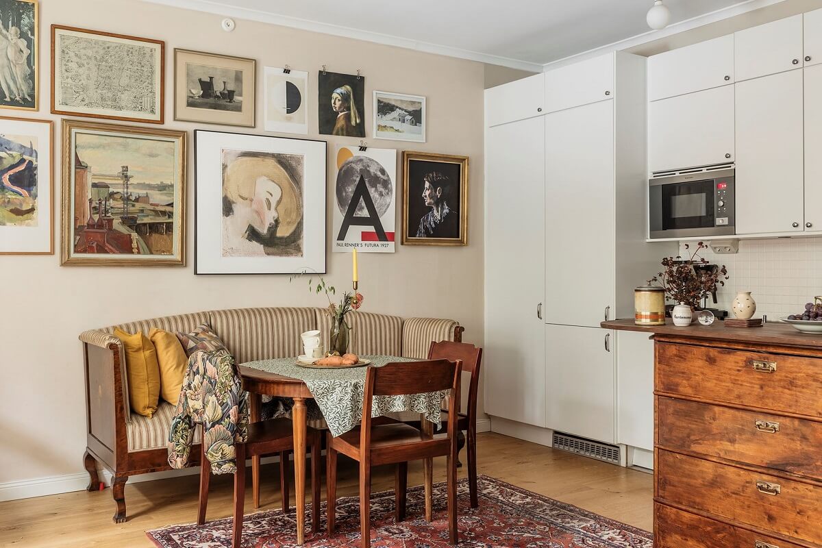 A Vintage Style Apartment in Stockholm 8 kitchen-dining-space-vintage-bench-gallery-wall-nordroom