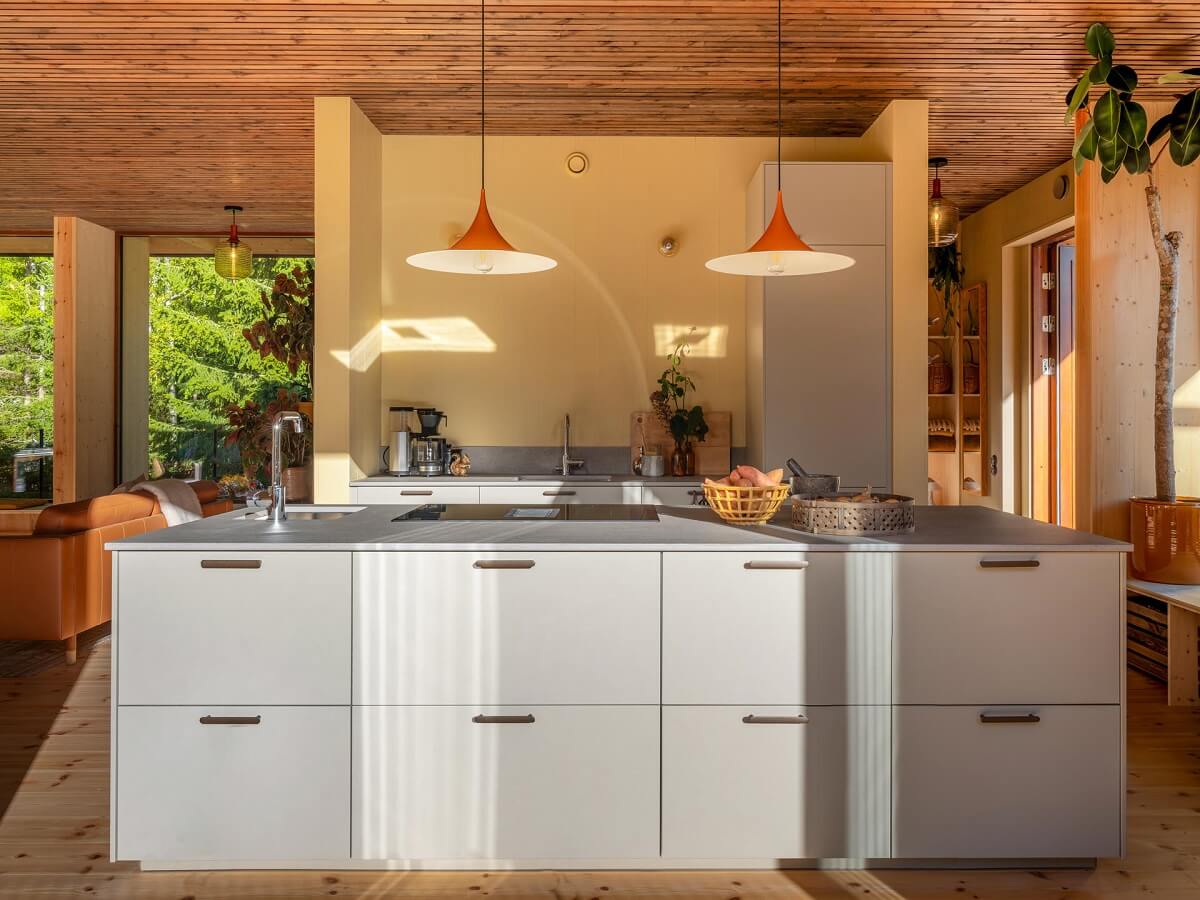 An Architectural Wooden Home with Open Spaces 9 kitchen-island-pale-yellow-accent-wall