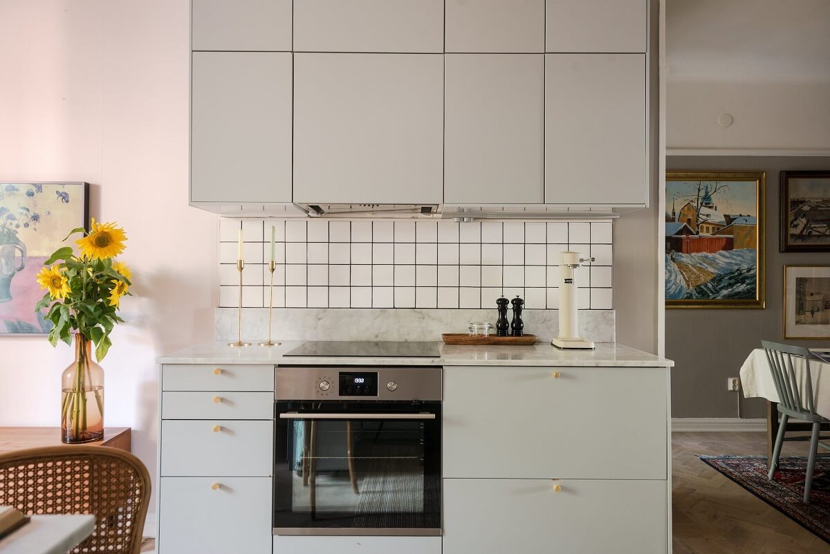 A Charming Open Plan Swedish Apartment 7 kitchen-square-white-tiles-nordroom