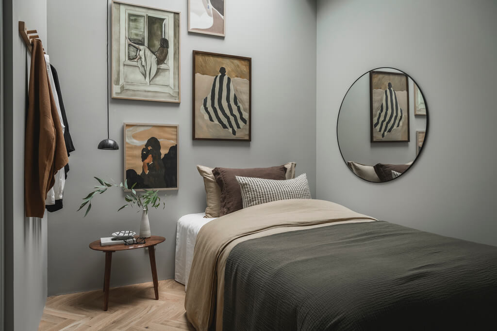 A Stylish Modern Gray Attic Apartment 17 light-gray-bedroom-gallery-wall-round-mirror-nordroom