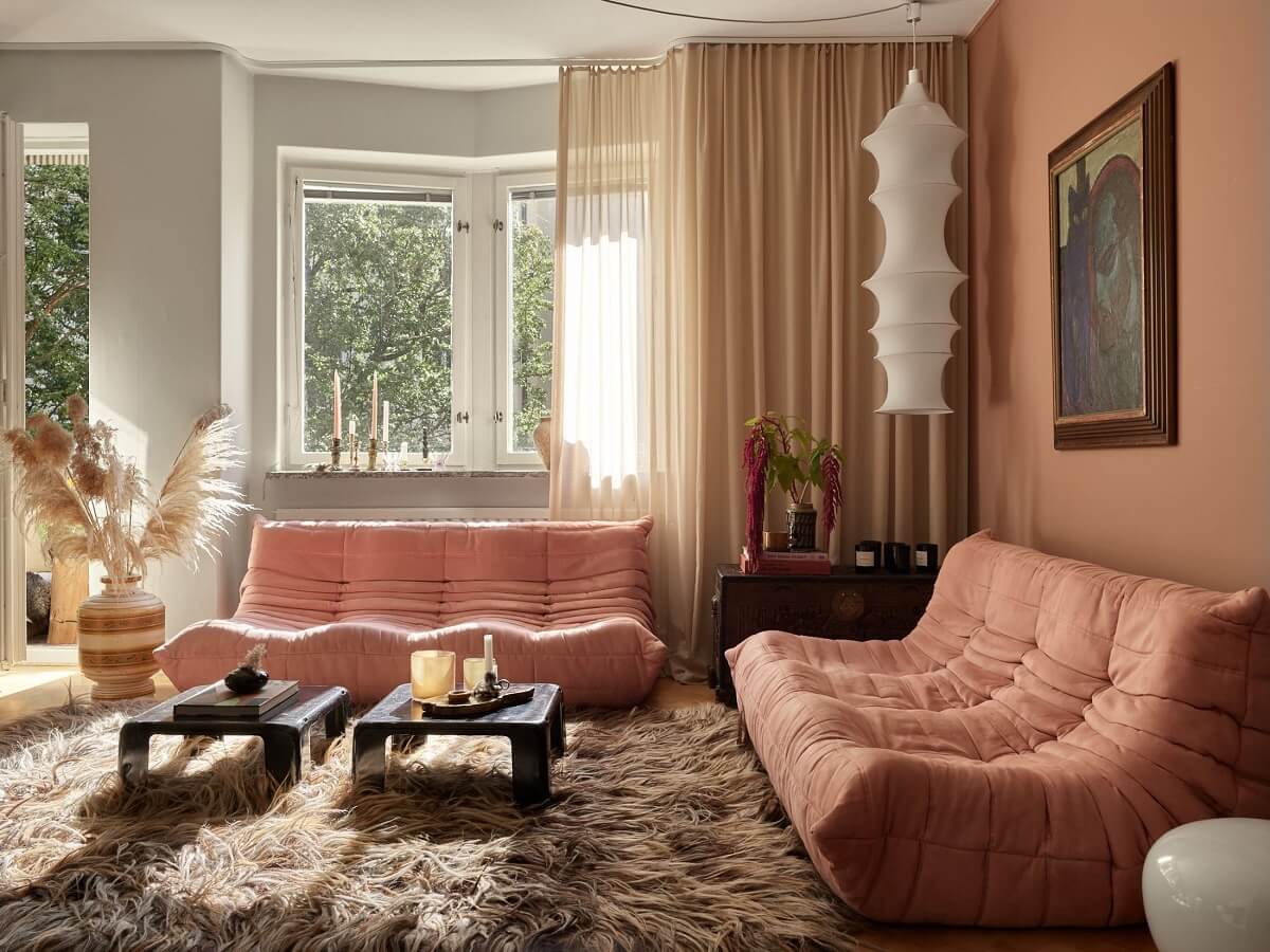 Warm Pink Tones in A Stockholm Apartment 4 living-room-pink-togo-sofa-large-rug-nordroom