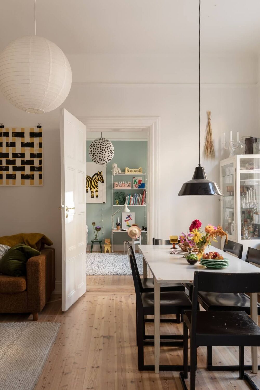 A Bright Scandinavian Apartment with a Light Gray Kitchen 14 living-room-with-dining-table