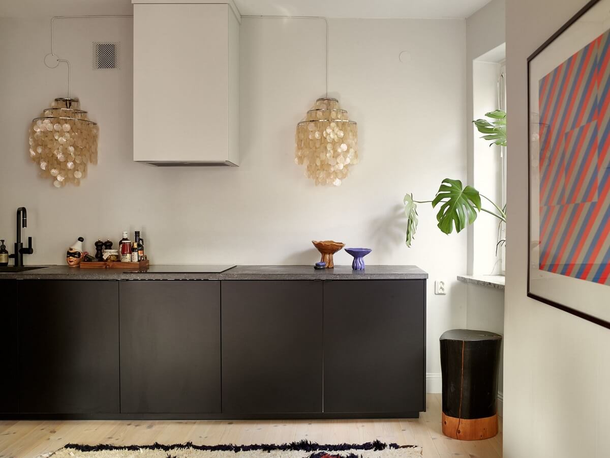 Warm Pink Tones in A Stockholm Apartment 8 modern-black-kitchen-artwork-nordroom