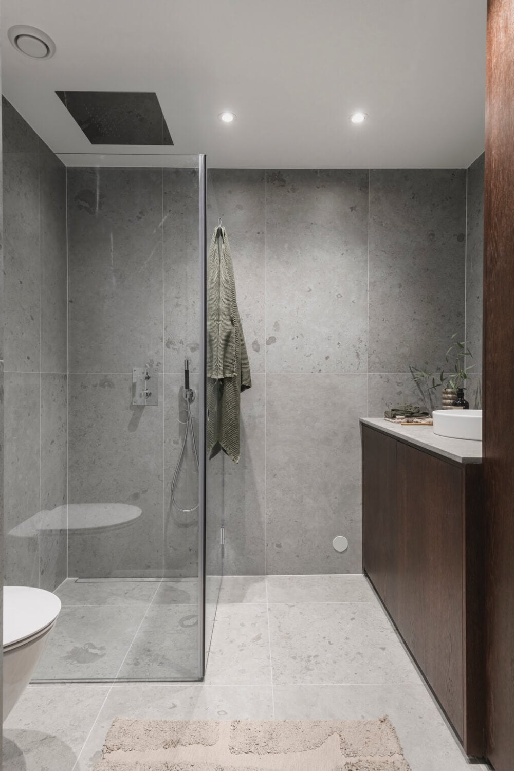 A Stylish Modern Gray Attic Apartment 20 modern-scandinavian-bedroom-gray-tiles-wooden-vanity-nordroom