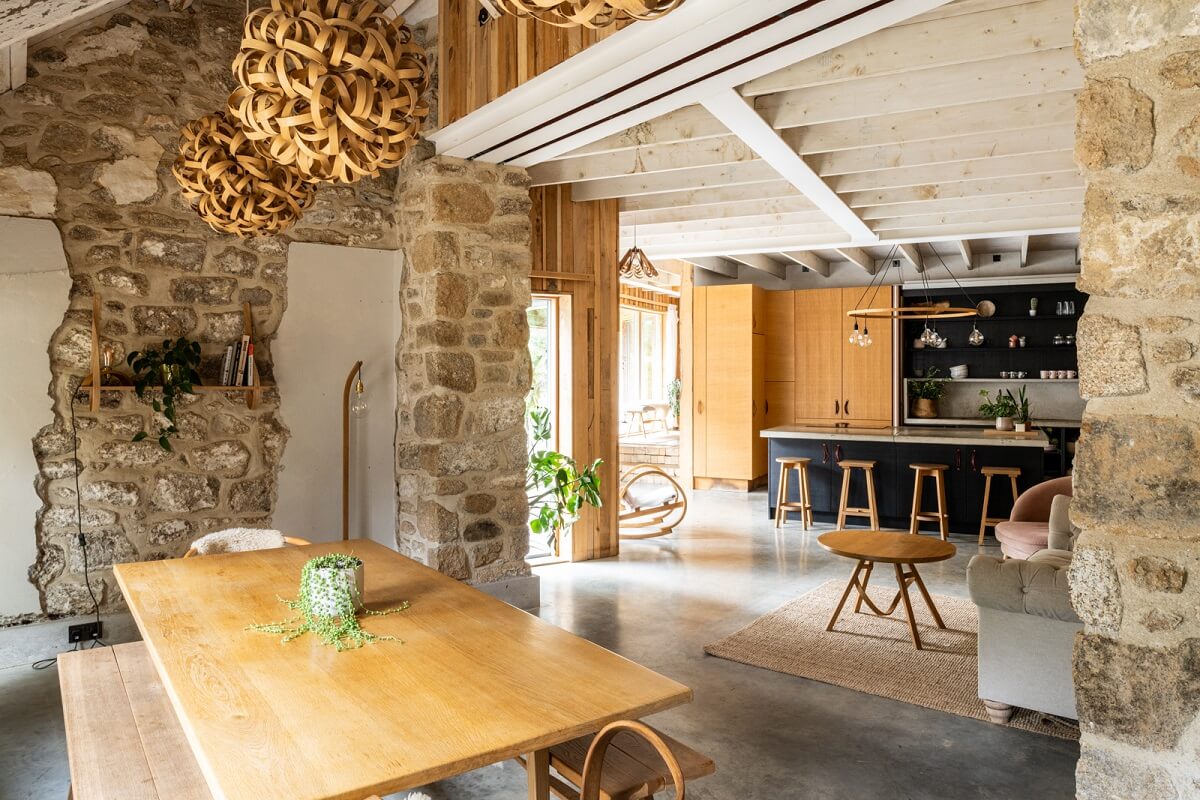 An English Country House That Pairs History with Contemporary Design 5 open-plan-kitchen-dining-space-raw-stone-wall-nordroom