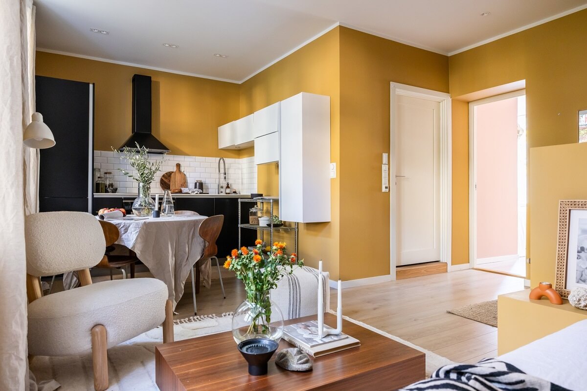 An Oslo Apartment with a Yellow Living Room 6 open-plan-living-kitchen-yellow-walls-black-kitchen-nordroom