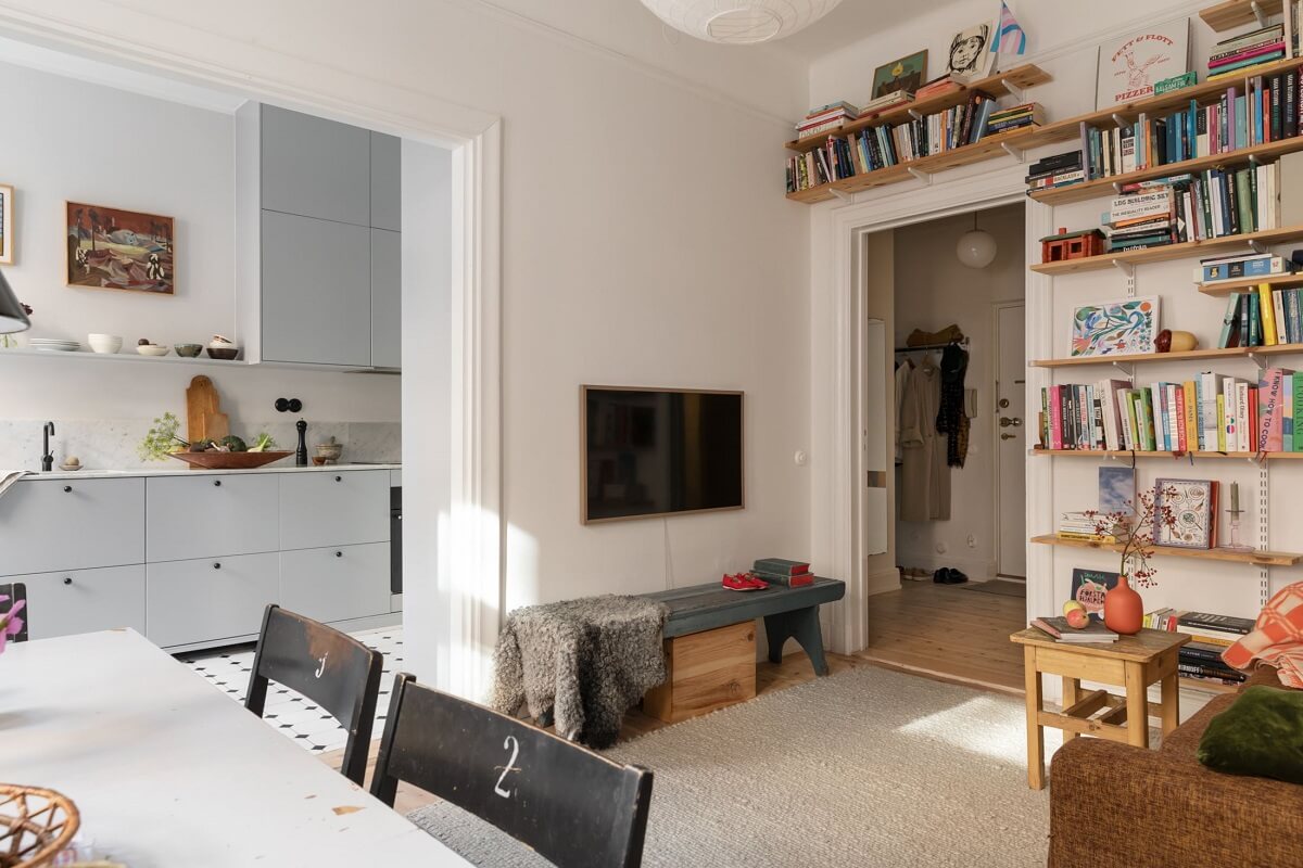 A Bright Scandinavian Apartment with a Light Gray Kitchen 4 open-plan-living-room-bookshelves-nordroom