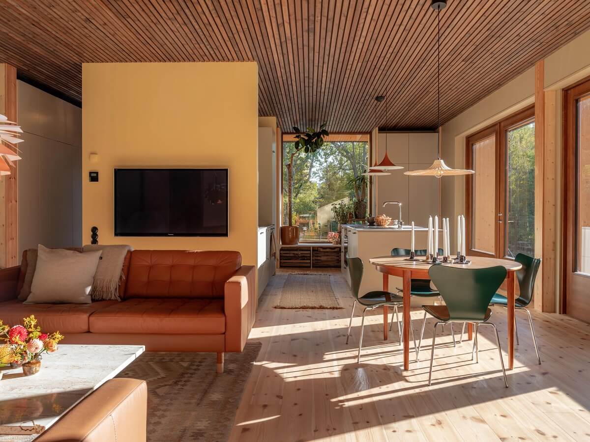 An Architectural Wooden Home with Open Spaces 4 open-plan-living-space-pale-yellow-accent-wall-nordroom