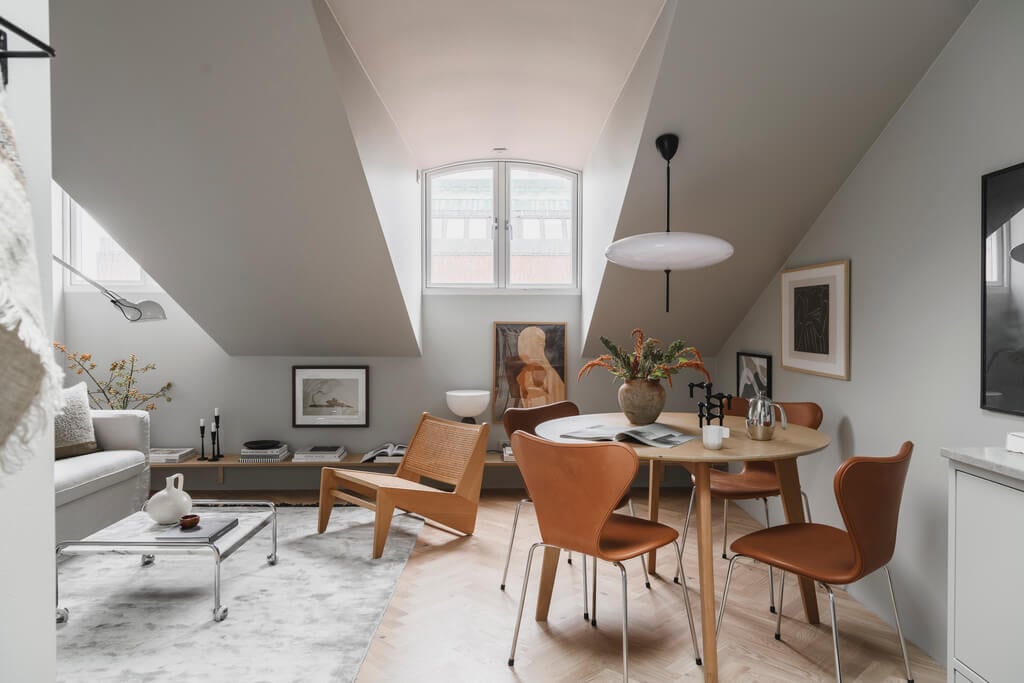 A Stylish Modern Gray Attic Apartment 5 white-scandinavian-living-room-slanted-ceiling-nordroom