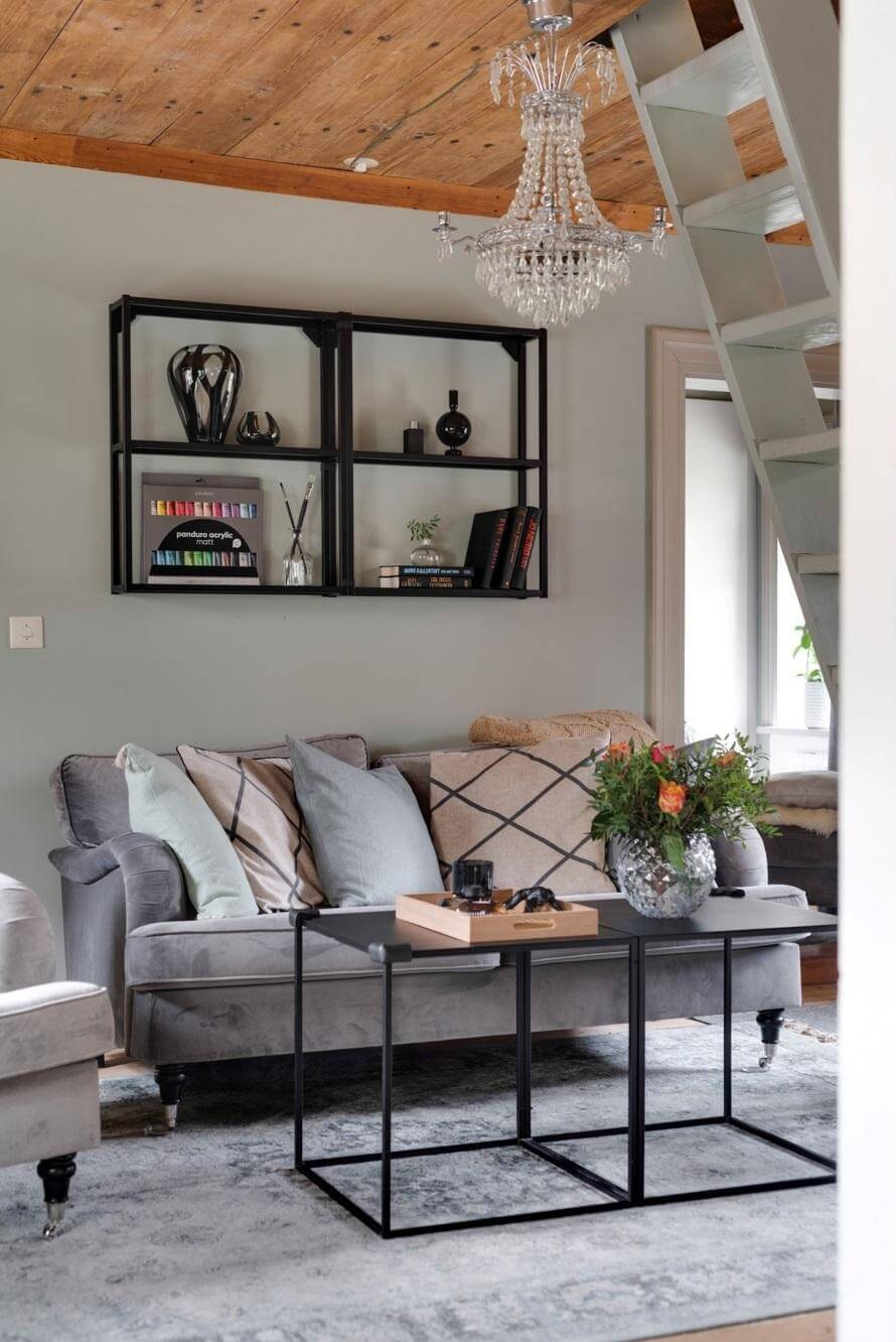 A Small 18th-Century Courtyard House in Sweden 3 scandi livng room gray sofa wooden ceiling