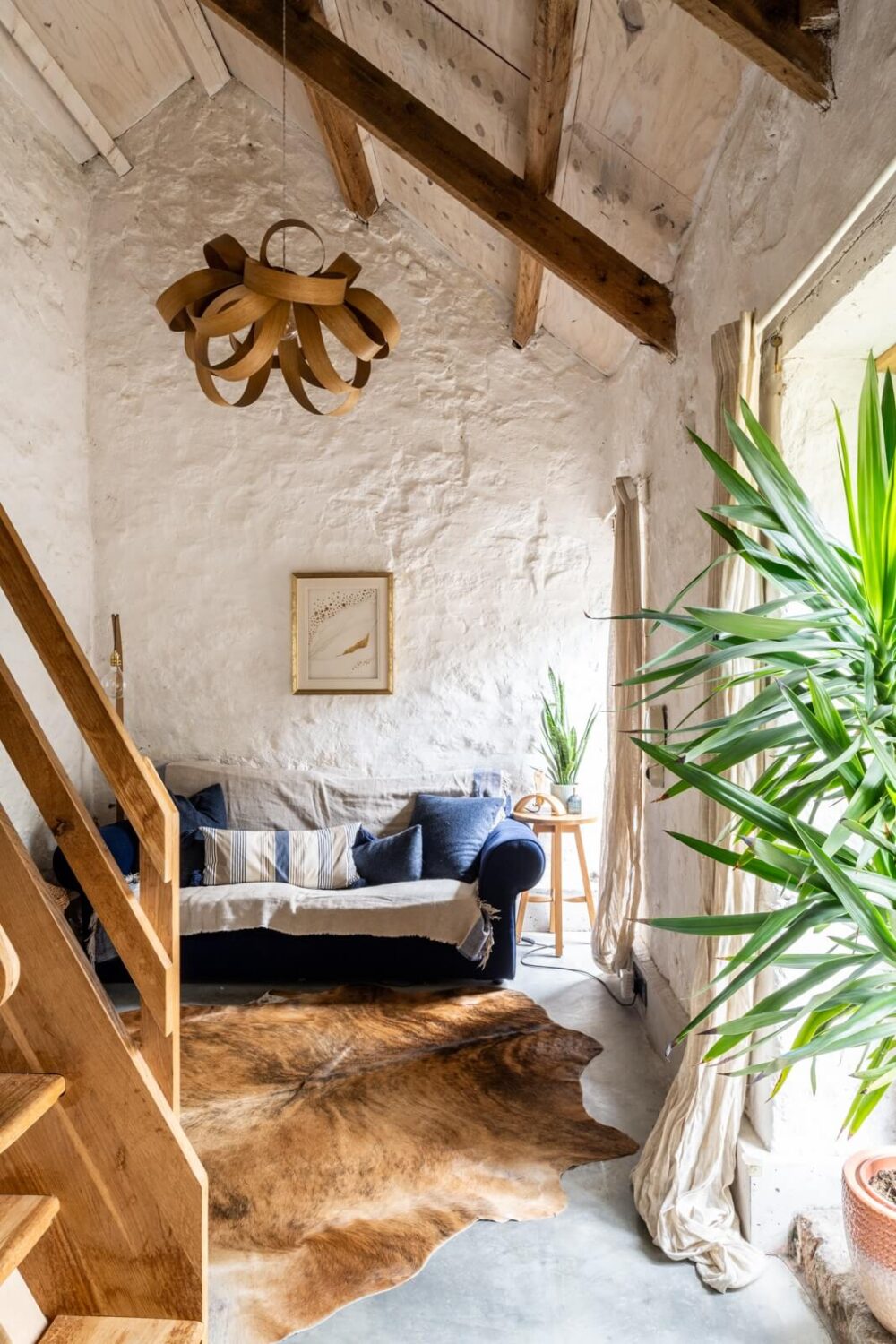 An English Country House That Pairs History with Contemporary Design 8 sitting-room-raw-stone-wall-arched-ceiling-nordroom