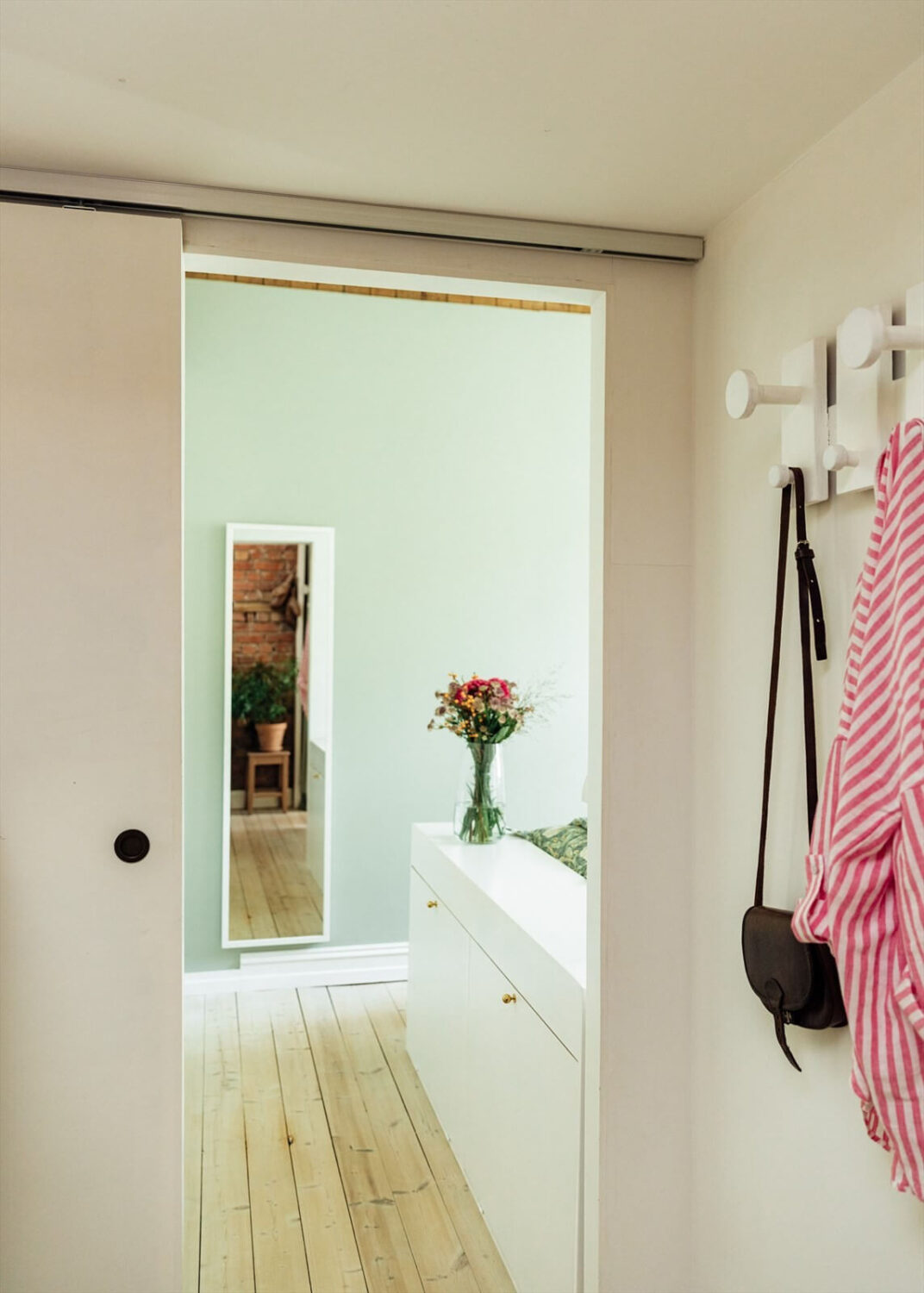 A Charming Norwegian Apartment with Wooden Walls 13 sliding-door-bedroom-wooden-floor-nordroom