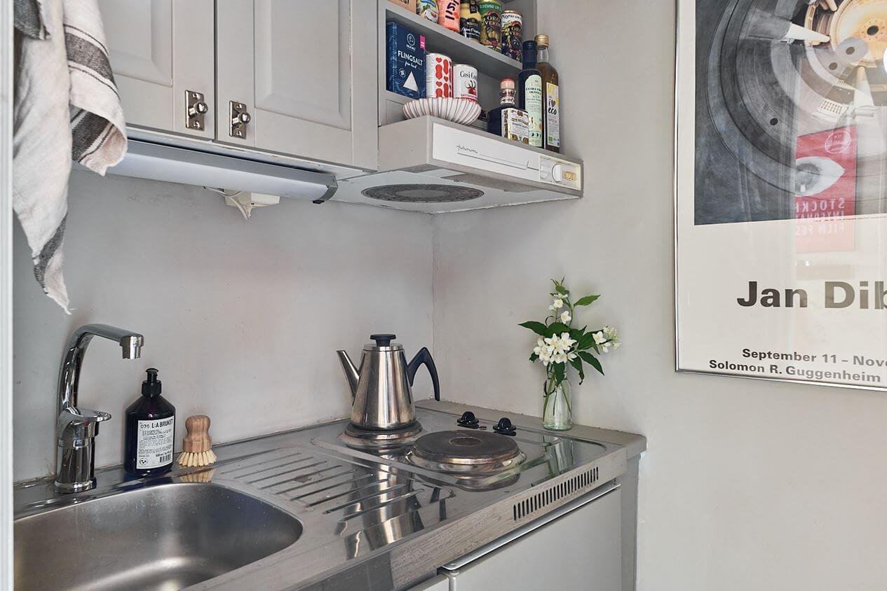 A Scandinavian Studio Apartment with Pink Walls 13 tiny-light-gray-kitchen-studio