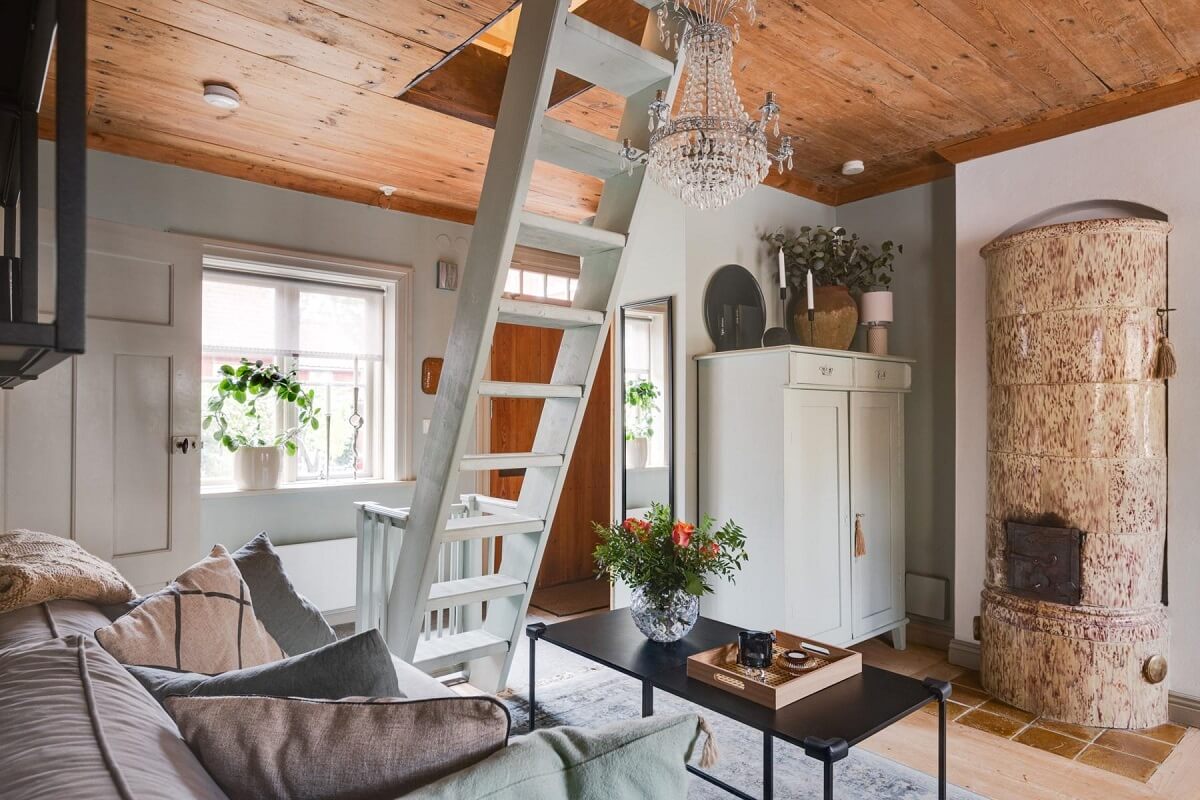 A Small 18th-Century Courtyard House in Sweden 4 tiny living room fireplace wooden ceiling