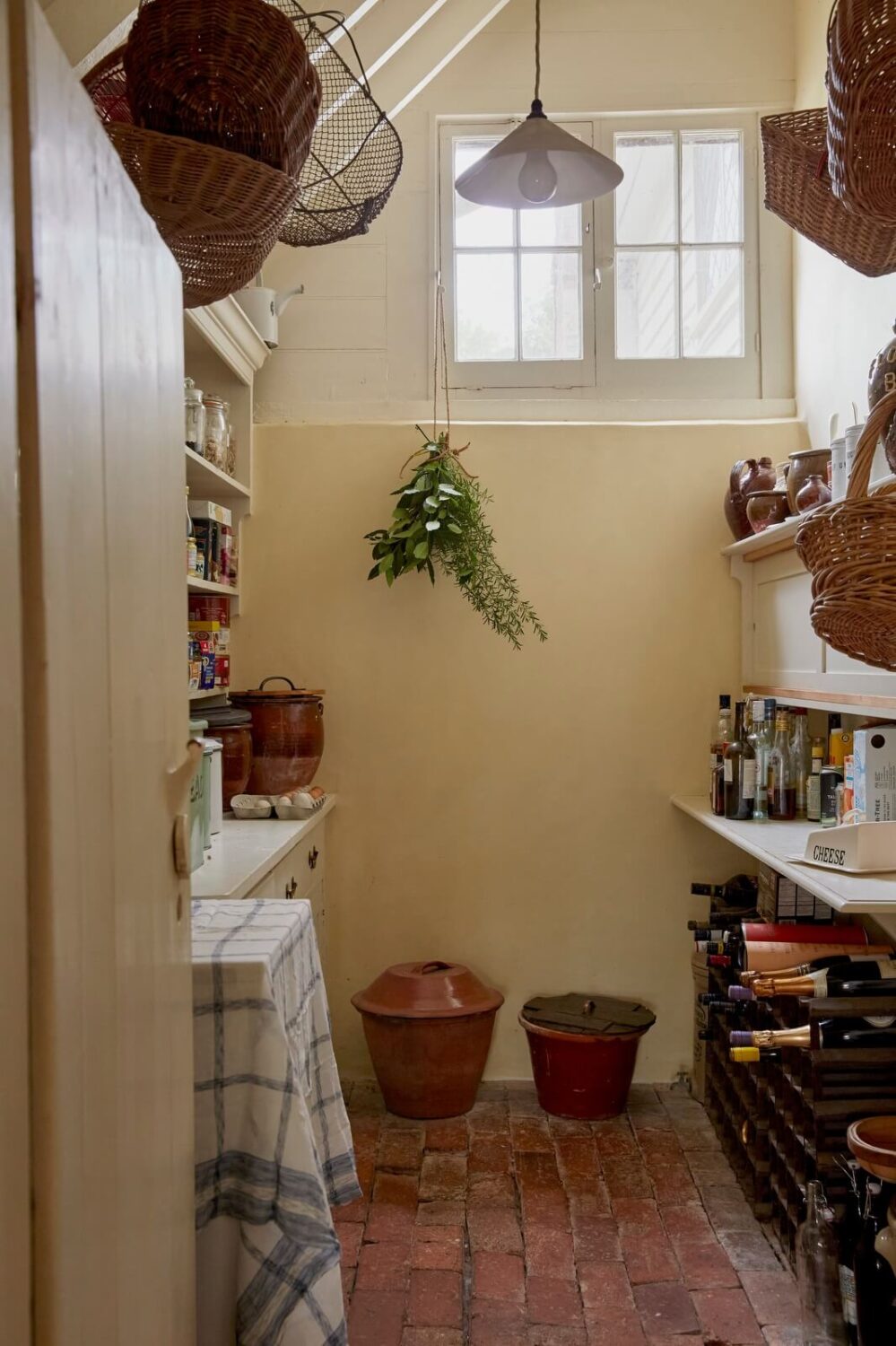 A Charming Historic Farmhouse with a Bright Yellow Kitchen 11 utility room stone floor english cottage