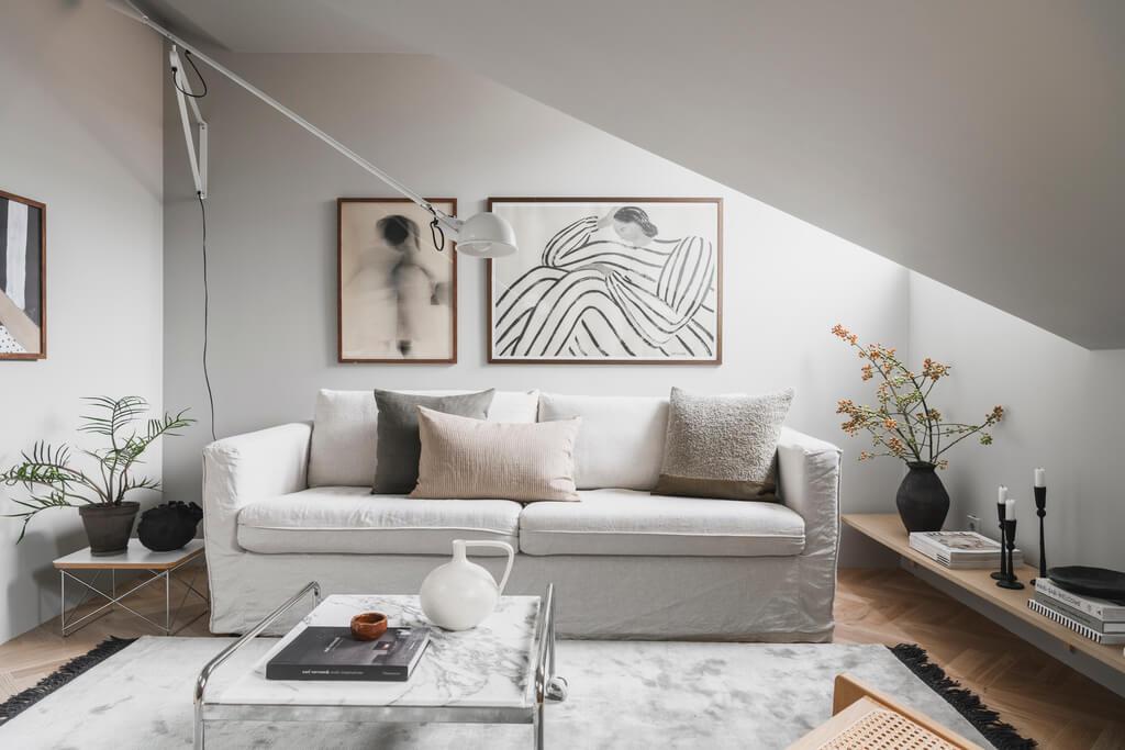 A Stylish Modern Gray Attic Apartment 4 white-scandinavian-living-room-slanted-ceiling-nordroom