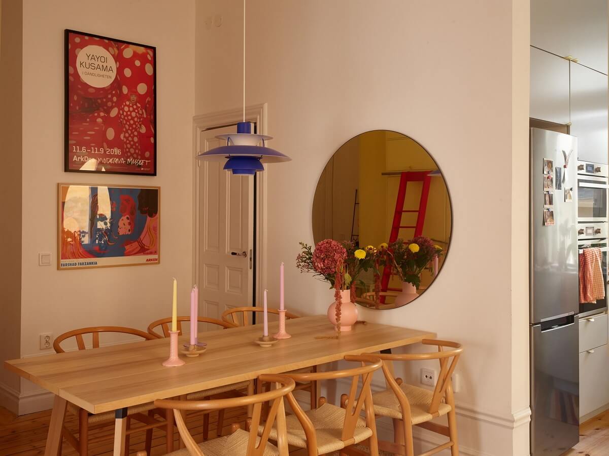 A Small Stockholm Apartment Filled with Color 8 wooden-dining-table-round-mirror
