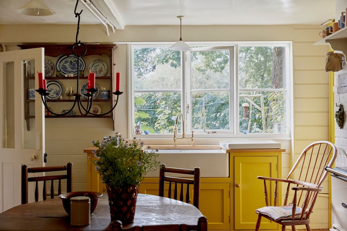 A Charming Historic Farmhouse with a Bright Yellow Kitchen 8 yellow cottage kitchen butler sink
