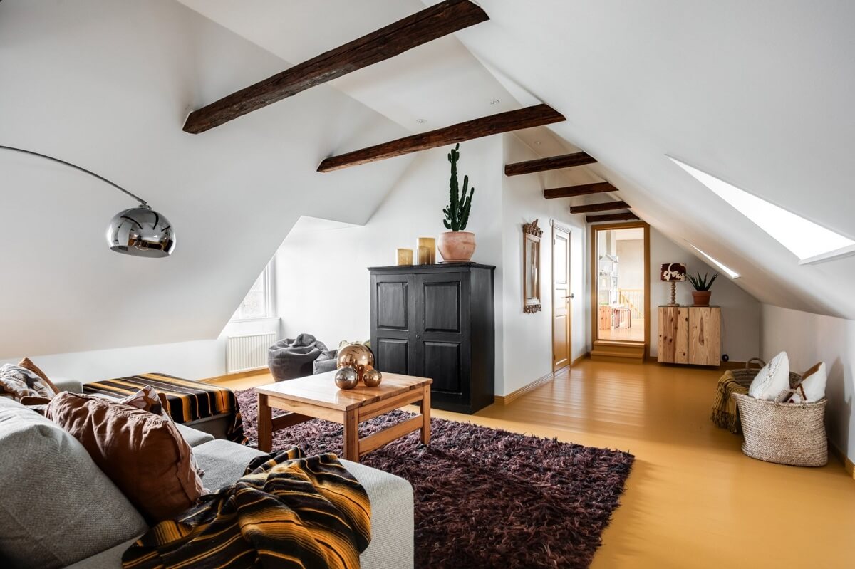 A Unique Bohemian Family Home in a Former Swedish Bakery 34 attic-living-room-yellow-floor-wooden-beams-nordroom
