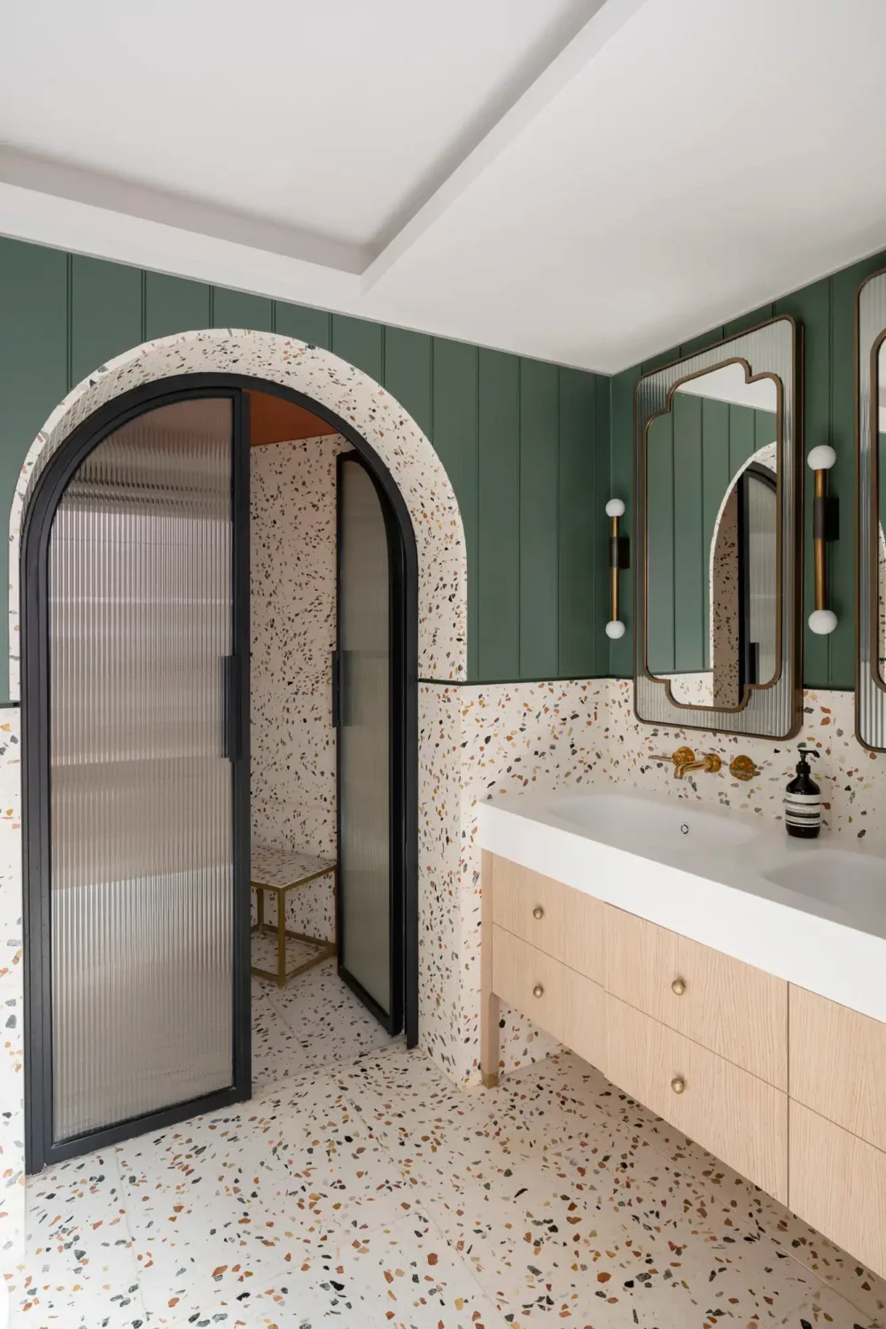 Best of 2023: Bathrooms 31 bathroom-green-walls-terrazzo-tiles-double-sink-arched-ribbed-glass-doors-nordroom