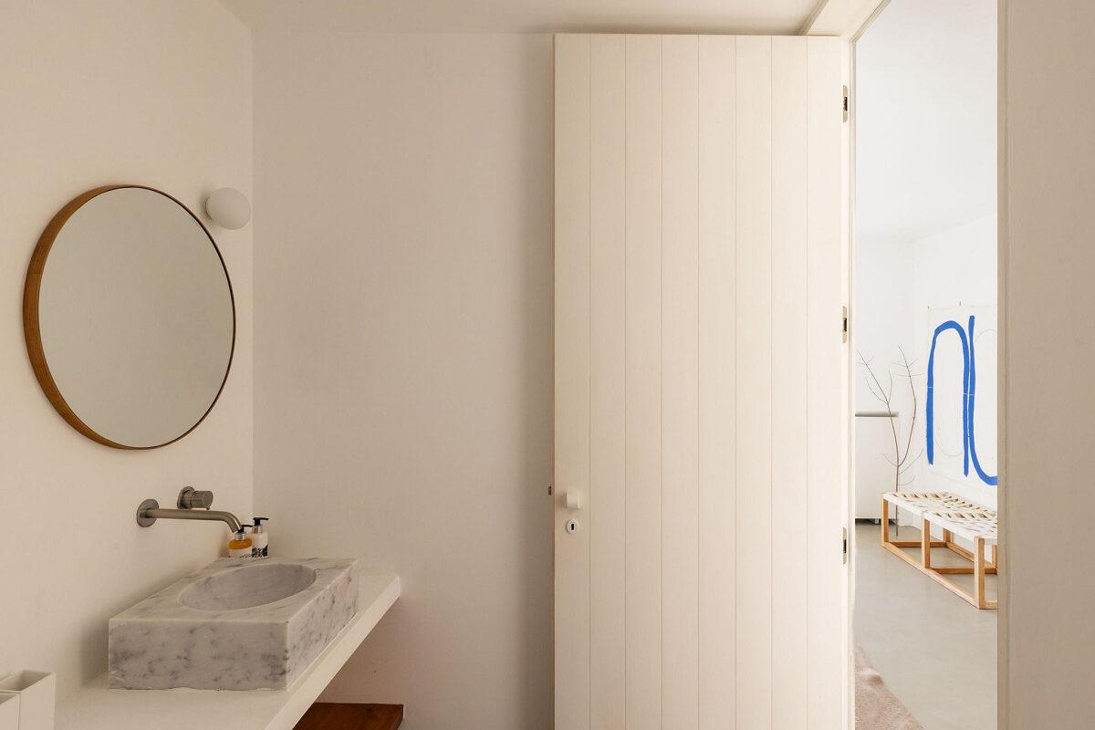 A Renovated 19th Century House with a Minimalistic Decor 11 bathroom-marble-sink-round-mirror-nordroom