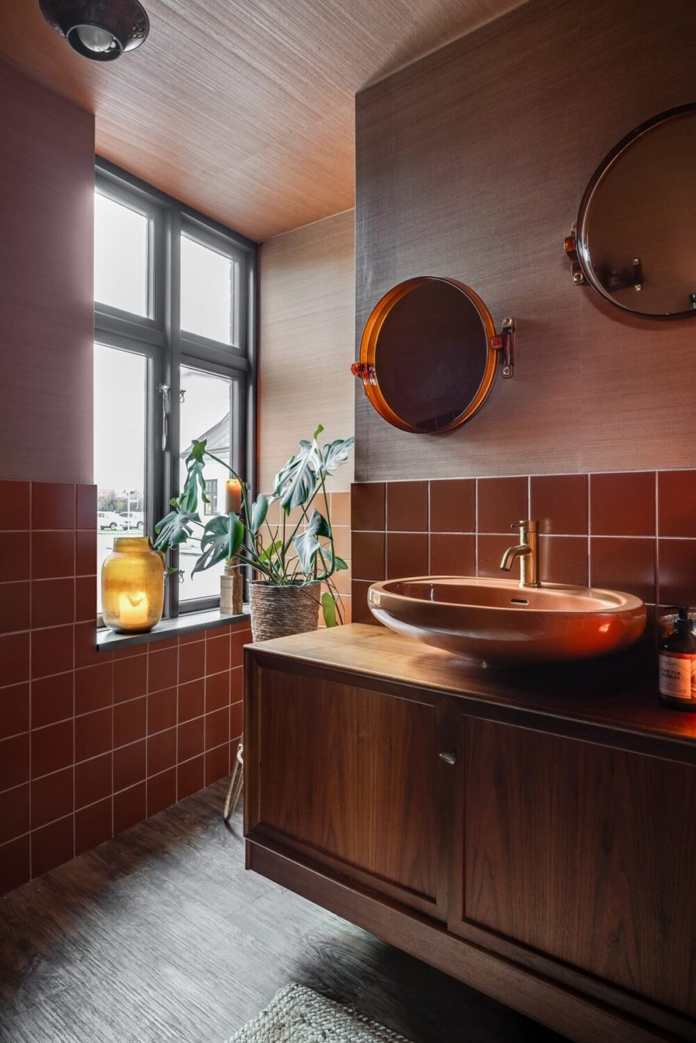A Unique Bohemian Family Home in a Former Swedish Bakery 31 bathroom-pink-walls-orange-red-tiles-nordroom
