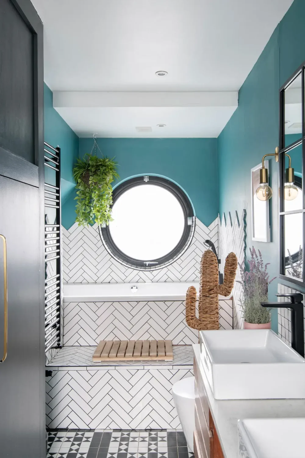A Spacious and Stylish Houseboat in London 15 bathroom white tiles bath round window houseboat london