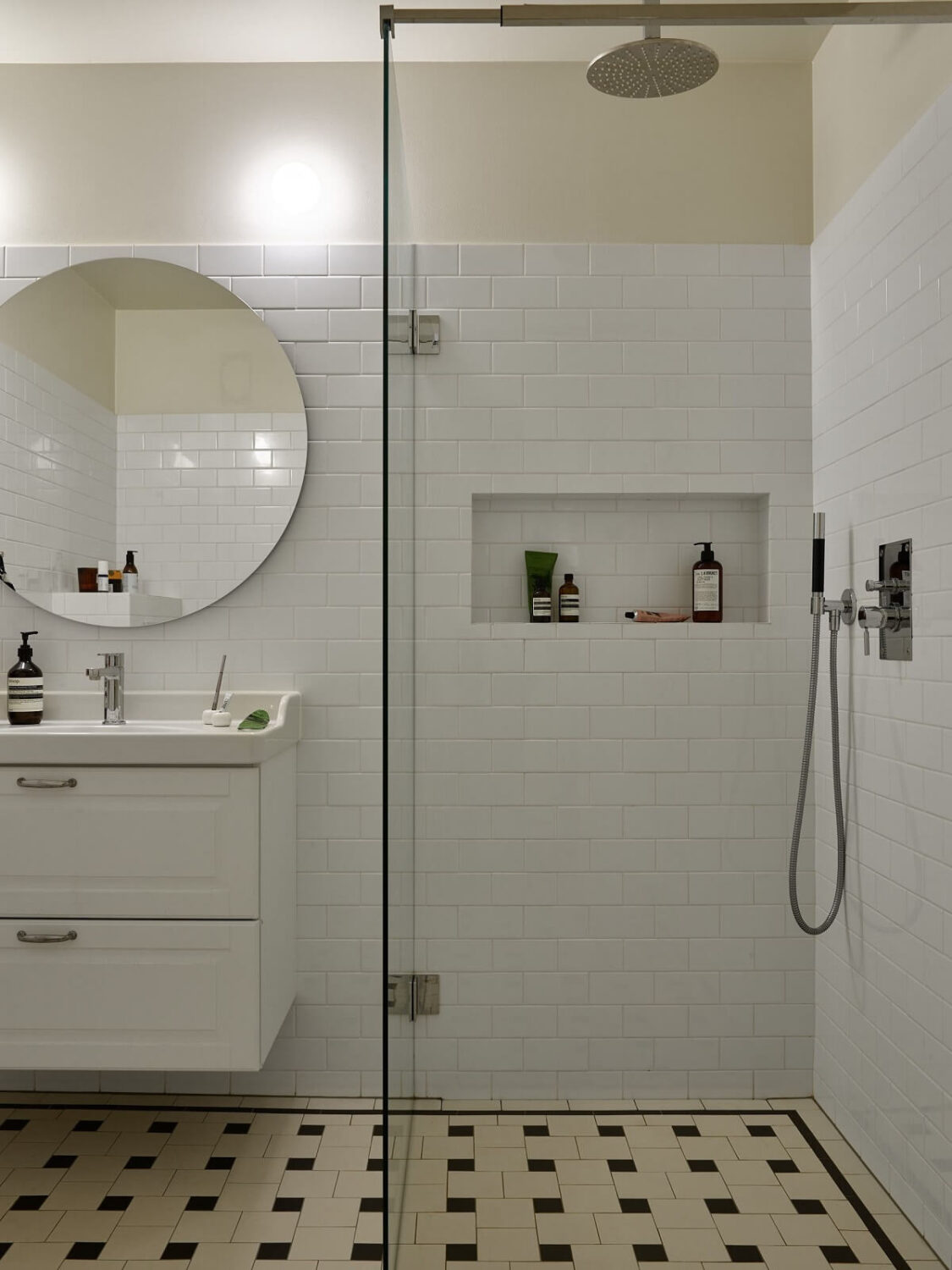 A Serene Light Colored Apartment with Bright Color Pops 18 bathroom white tiles storage niche