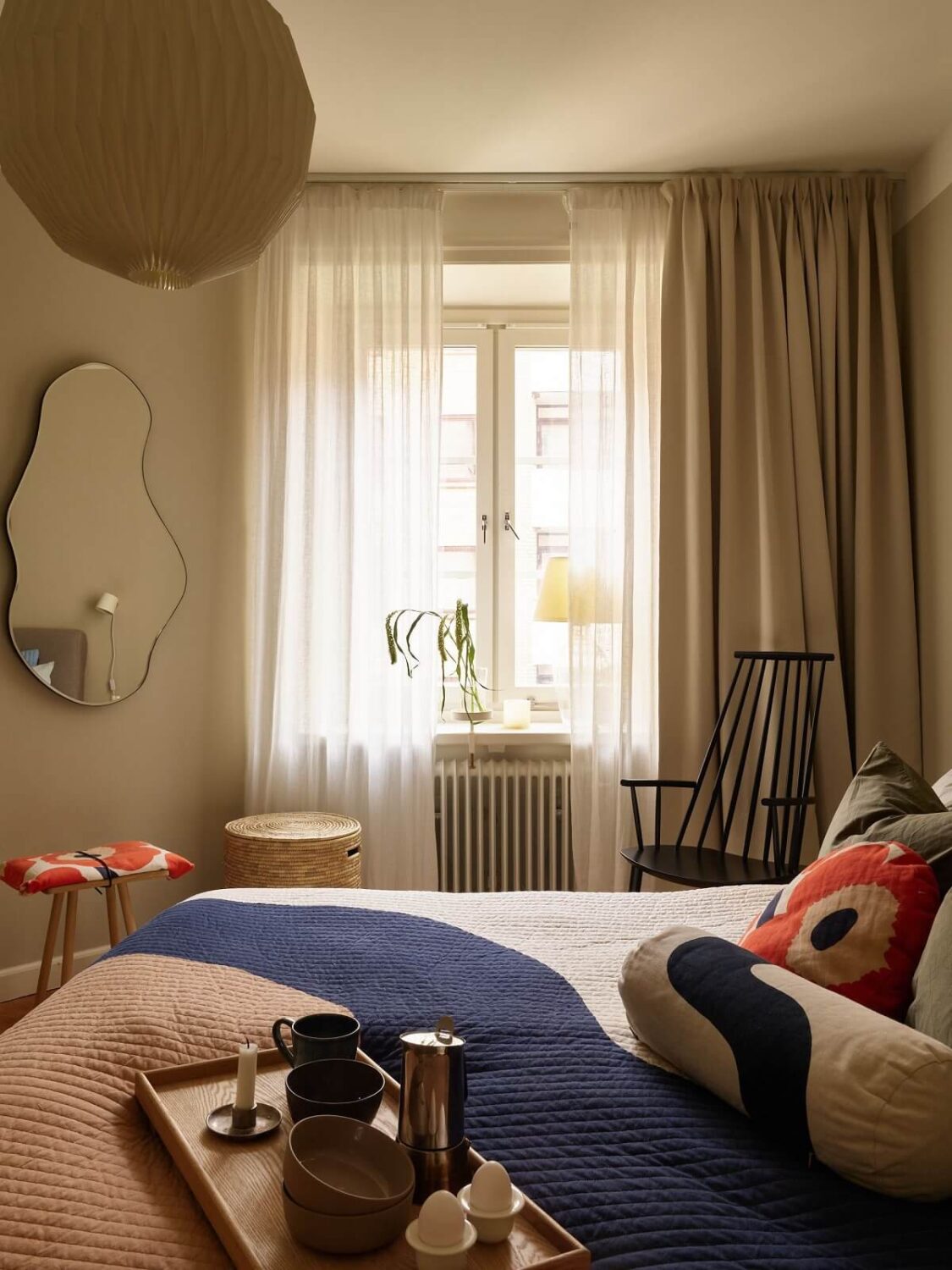 A Serene Light Colored Apartment with Bright Color Pops 16 bedorom gray walls colorful bedding