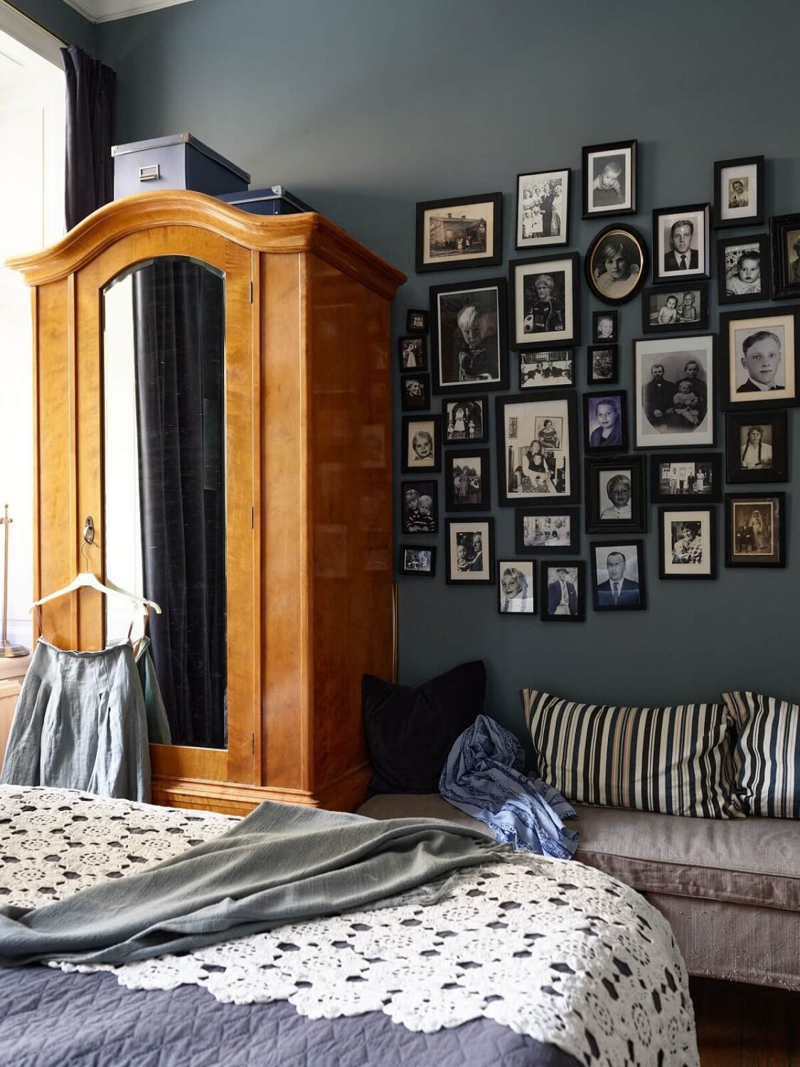 A Warm Vintage Apartment in Stockholm 12 bedroom-blue-wall-picture-gallery-antique-wardrobe-nordroom