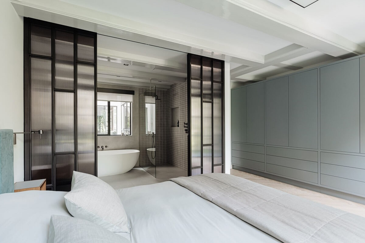 A Luxurious Amsterdam Canal House with High Ceilings 21 bedroom en suite bathroom steel ribbed glass doors built in wardrobes