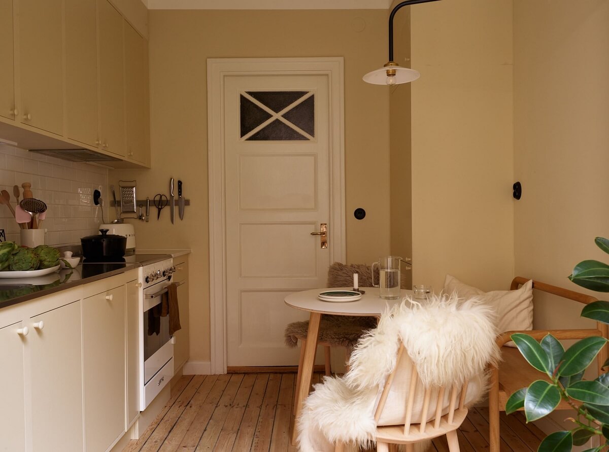 A Serene Light Colored Apartment with Bright Color Pops 4 beige scandinavian kitchen small round table