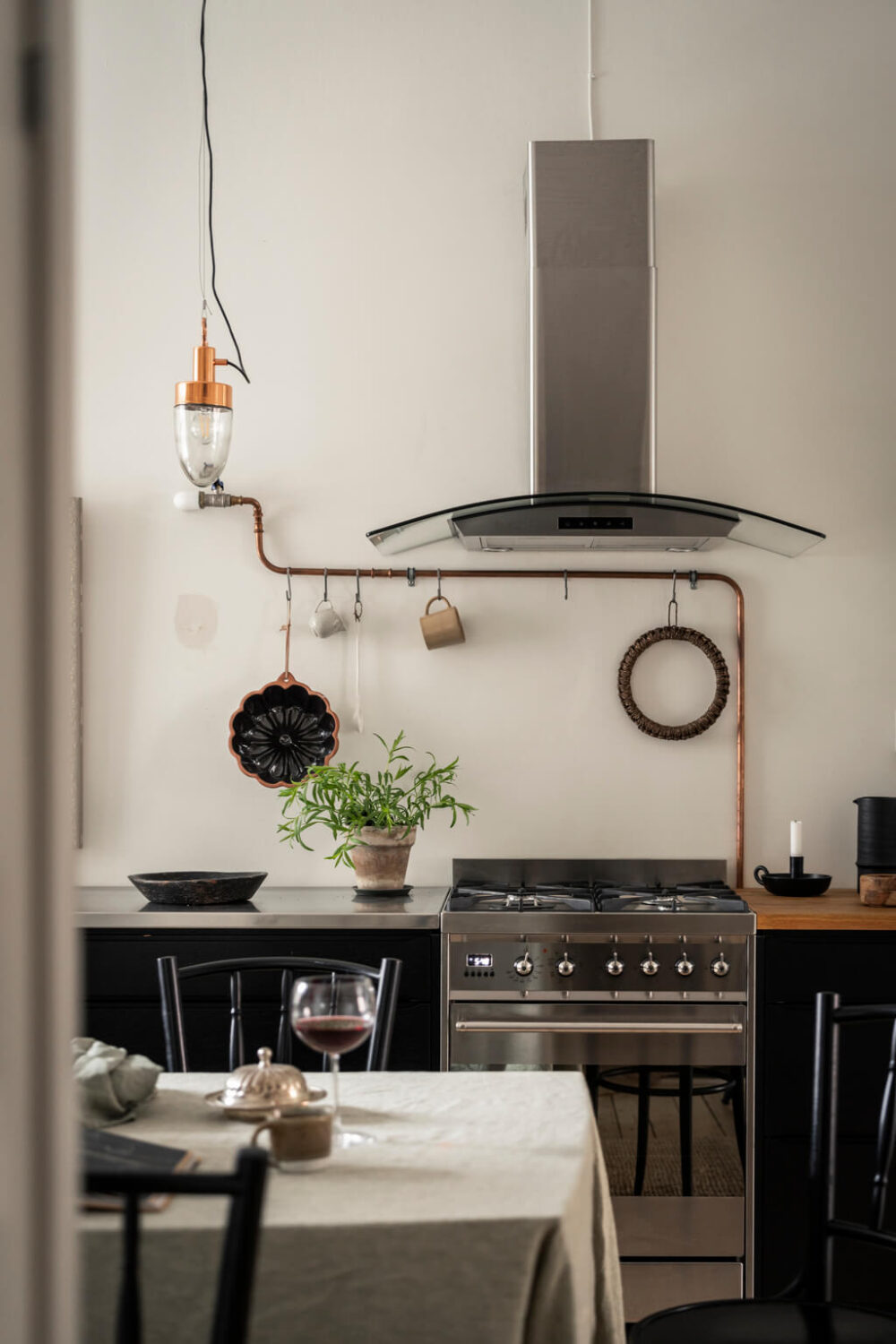 A Scandinavian Studio Apartment with Black Walls 19 black cabinets kitchen