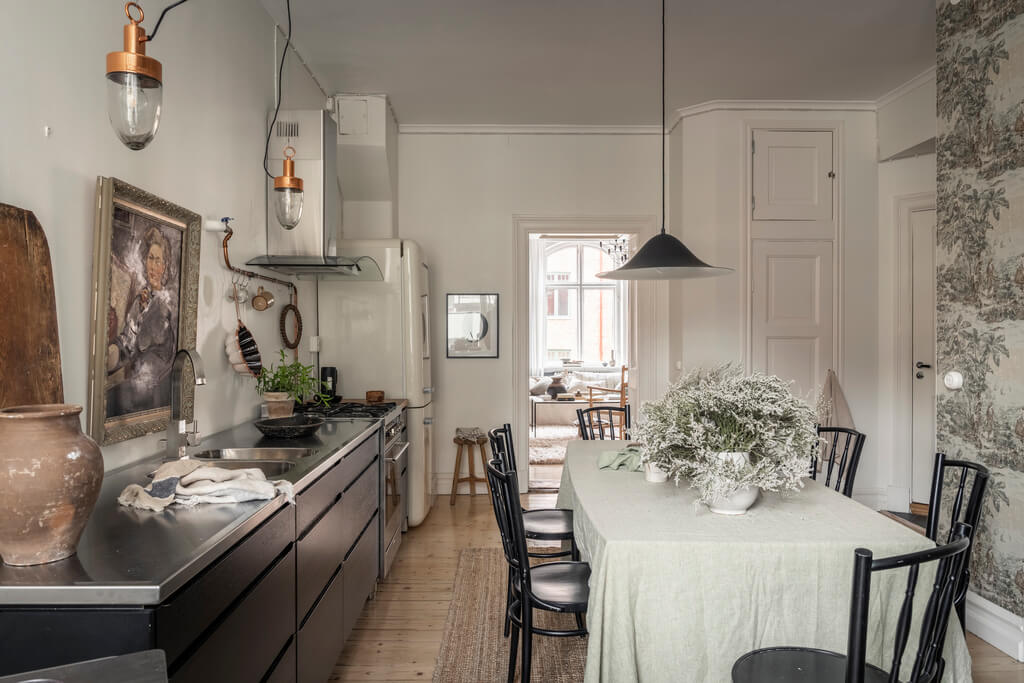 A Scandinavian Studio Apartment with Black Walls 20 black kitchen with dining table