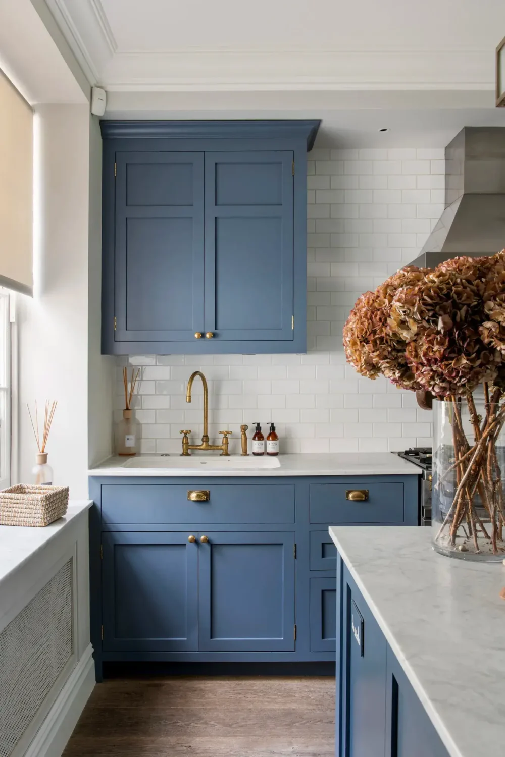 Muted Colors and Classic Design in a London Townhouse 11 blue-kitchen-cabinets-brass-handles-london-home-nordroom