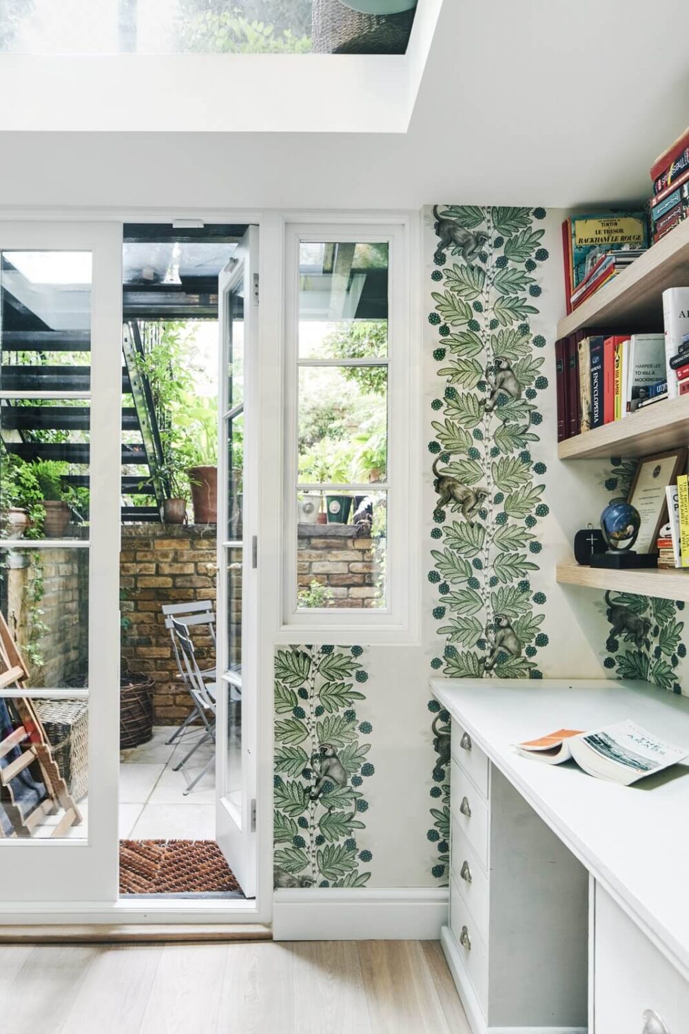 Blue Color Accents in a Restored London Townhouse 24 bright-basement-home-office-green-wallpaper