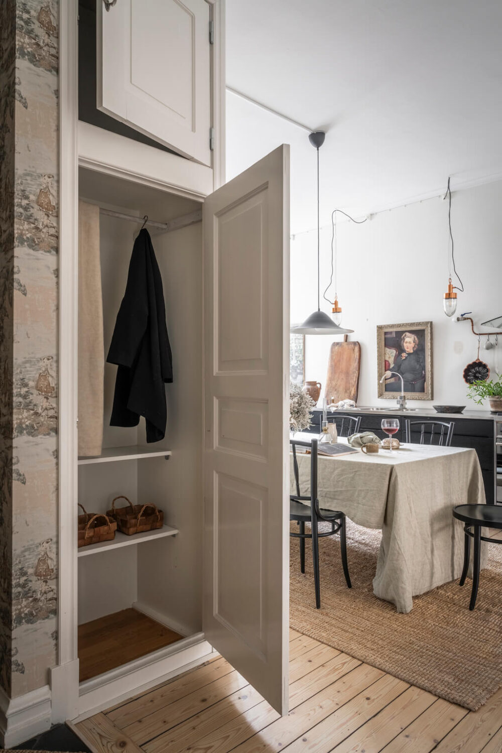 A Scandinavian Studio Apartment with Black Walls 21 built in wardrobes wooden floor open plan hallway kitchen