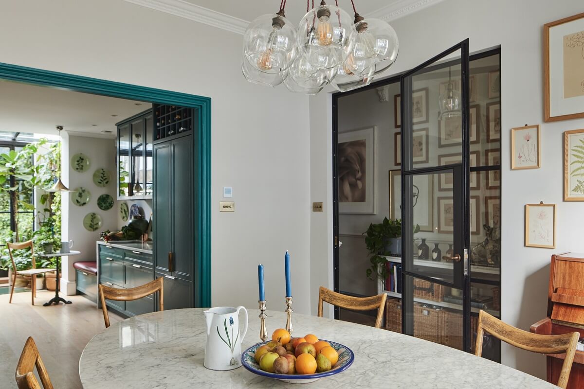Blue Color Accents in a Restored London Townhouse 15 dining-room-oval-table-steel-glass-doors-nordroom