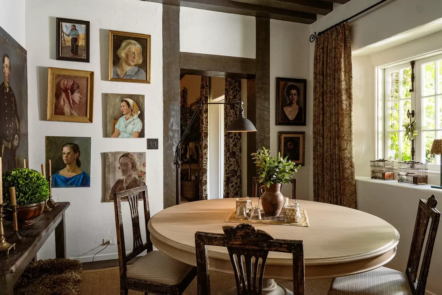 A Cozy Montecito Home Once Owned by Larry David 5 dining-room-round-table-gallery-wall