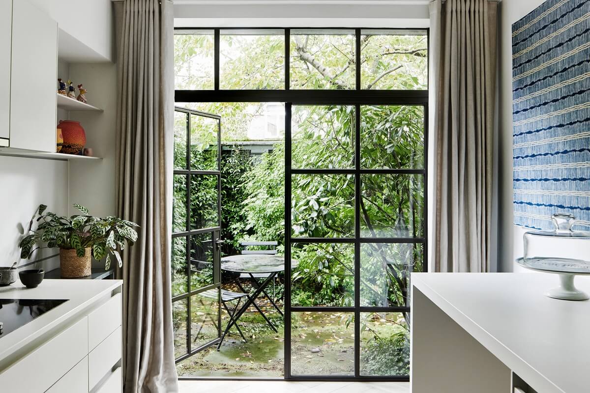 Stylish Monochrome Interiors in an Early 20th Century House 11 garden-access-kitche-white-cabinets-nordroom