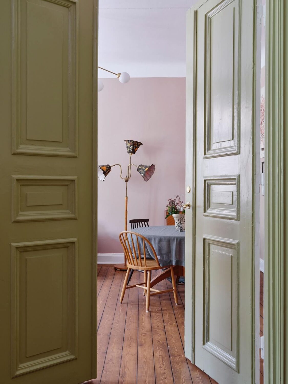 A Scandi Apartment Mixes Vintage with Contemporary Design 8 green-double-wooden-doors-living-room-view-nordroom