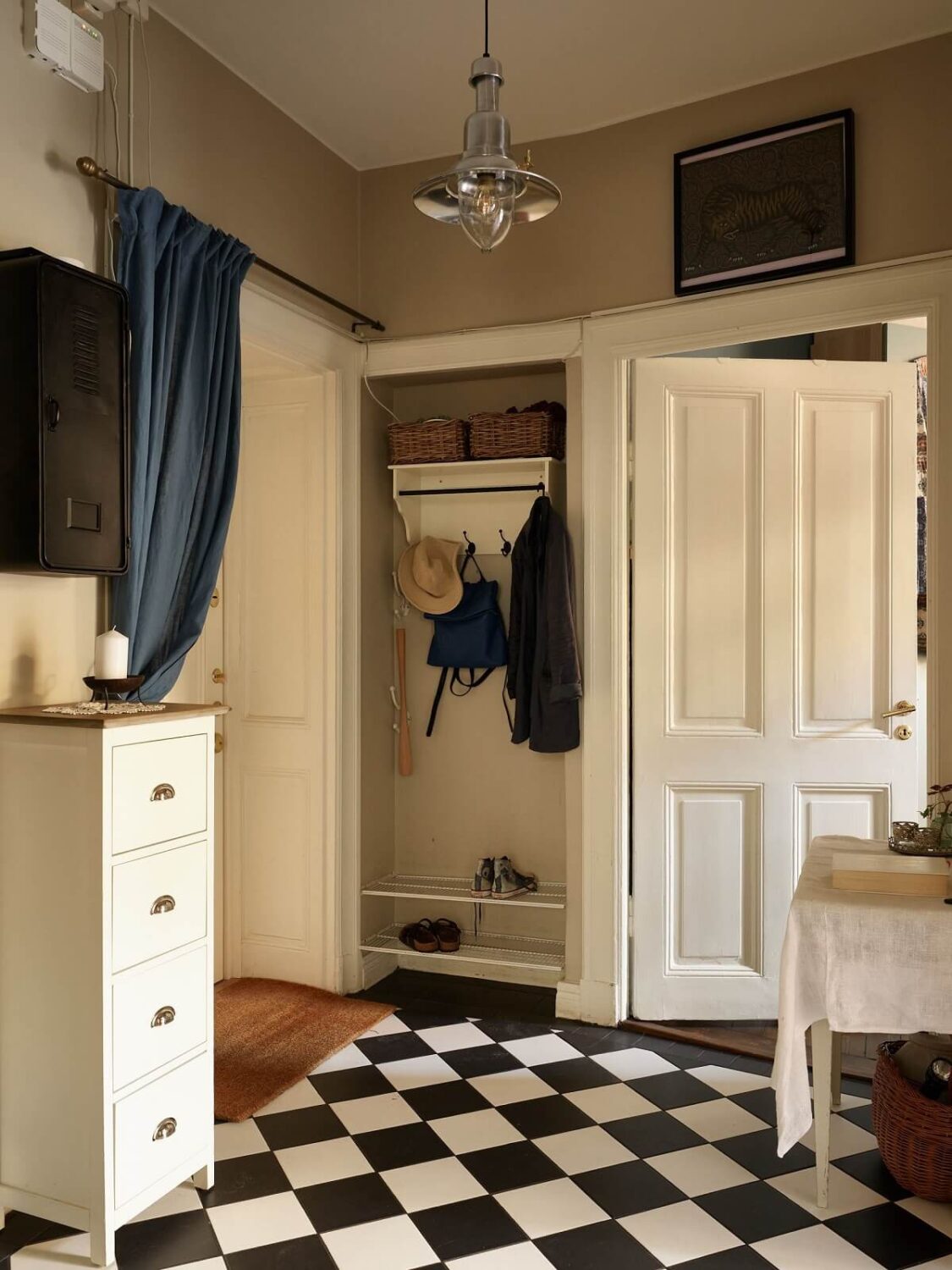 A Warm Vintage Apartment in Stockholm 17 hallway-black-white-checkerboard-floor-nordroom