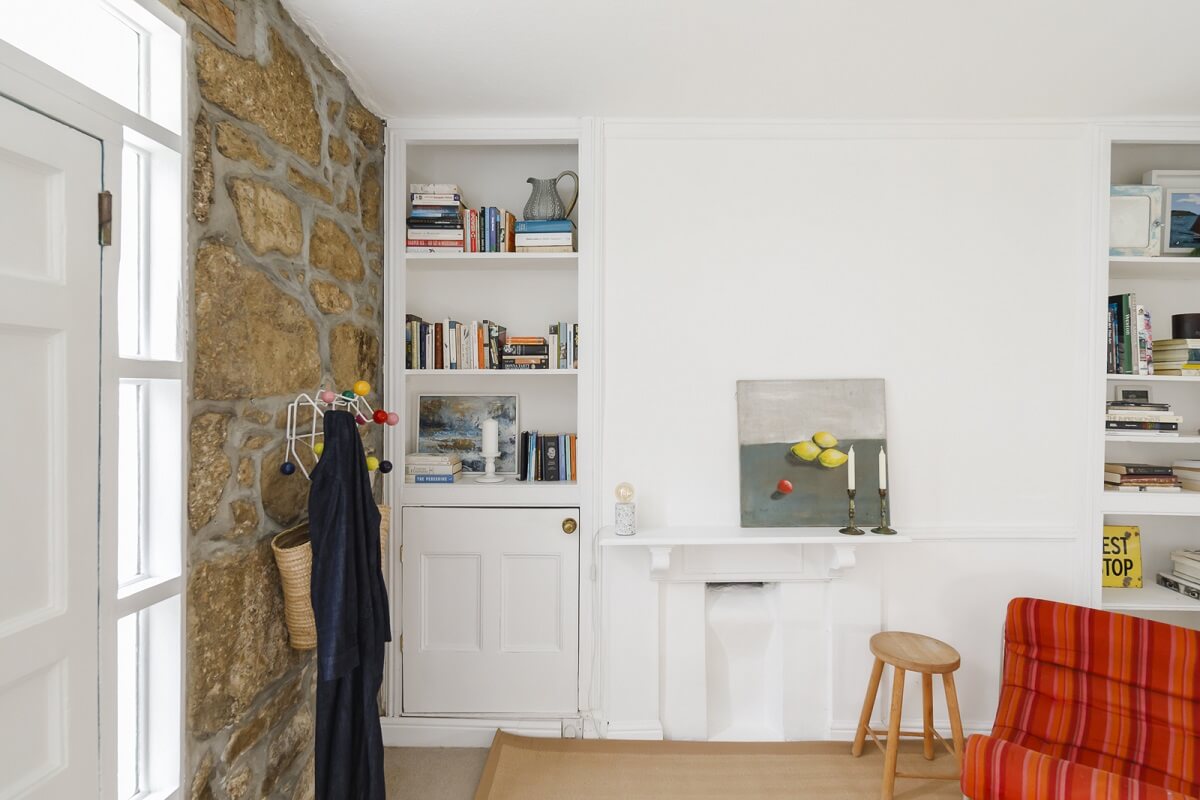 A Light Coastal Home in England 11 hallway room stone wall bookshelf niches