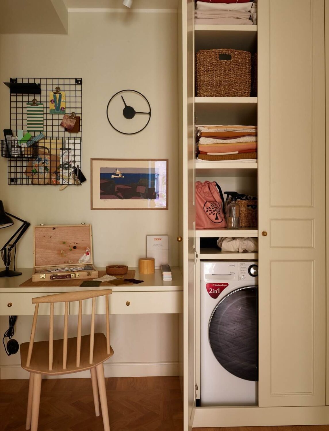 A Serene Light Colored Apartment with Bright Color Pops 13 home office built in closet with washing machine
