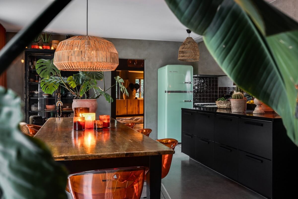 A Unique Bohemian Family Home in a Former Swedish Bakery 10 kitchen-detail-black-cabinets-dining-table-orange-chairs-nordroom